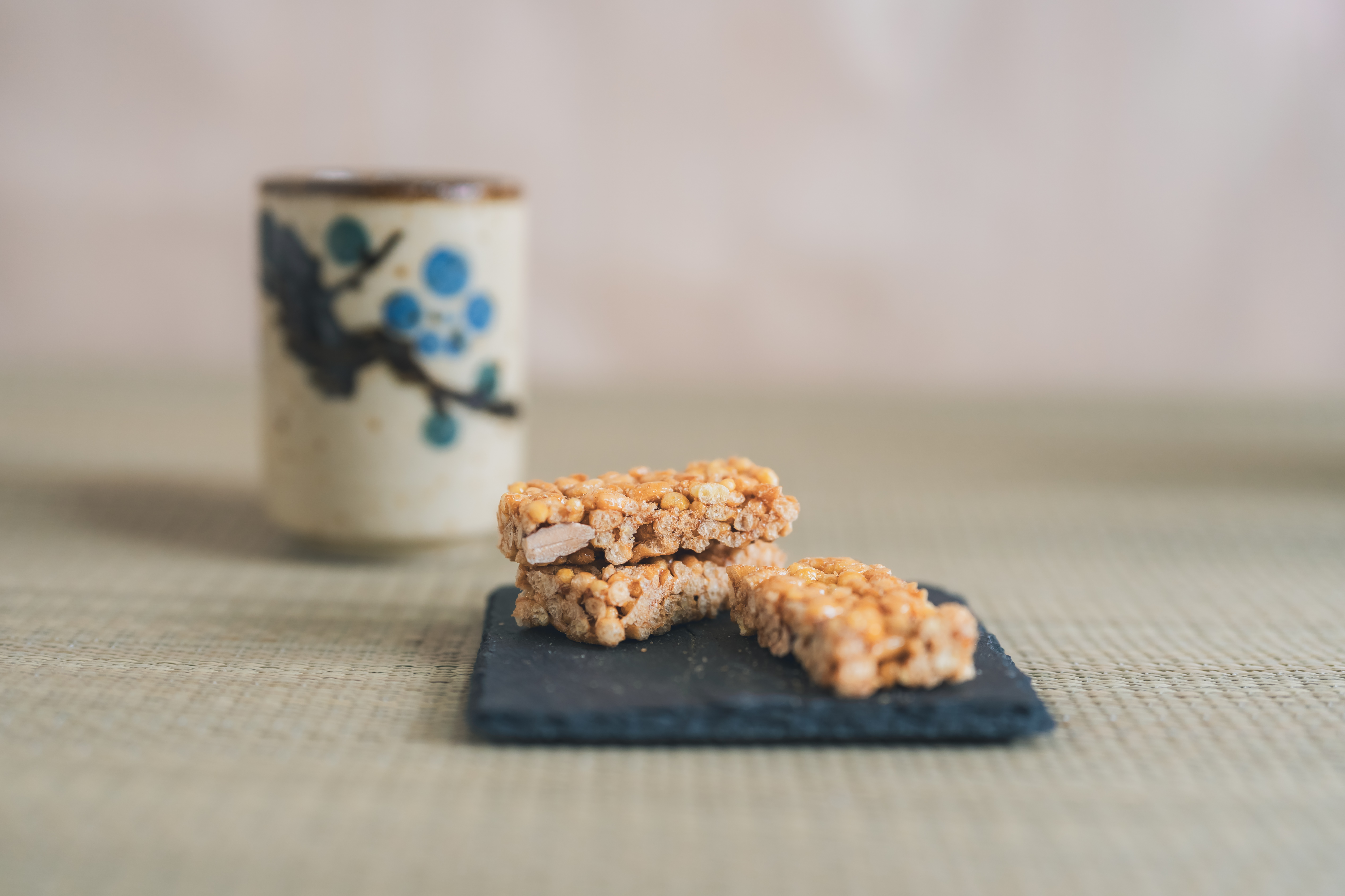 Caramel Kaminari Okoshi served with tea — a small, quiet taste of Tokyo.